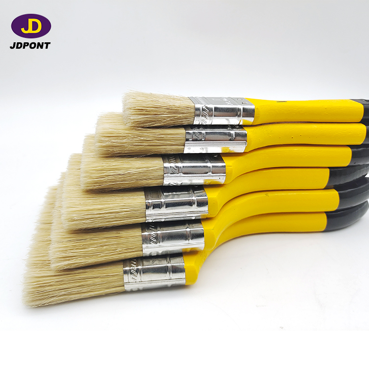 Yellow wooden handle bristle filament paintbrush for most of the paint